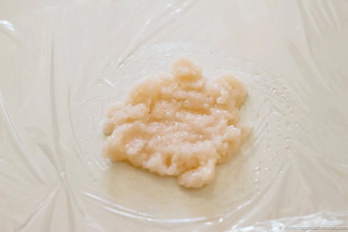 cooked domyojiko flattened on the plastic wrap