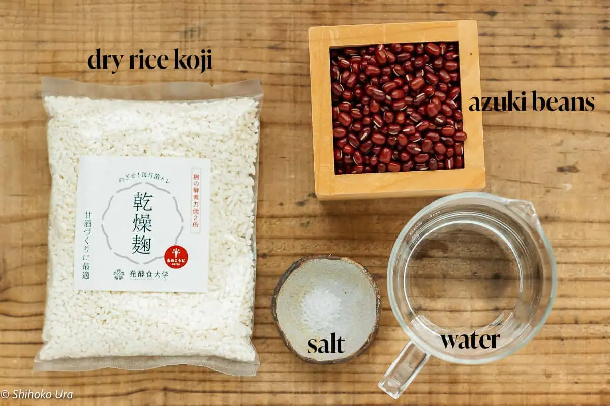 sweet red beans ingredients-azukibeans, dried rice koji packet, pinch of salt in a small bowl, and a jag of water