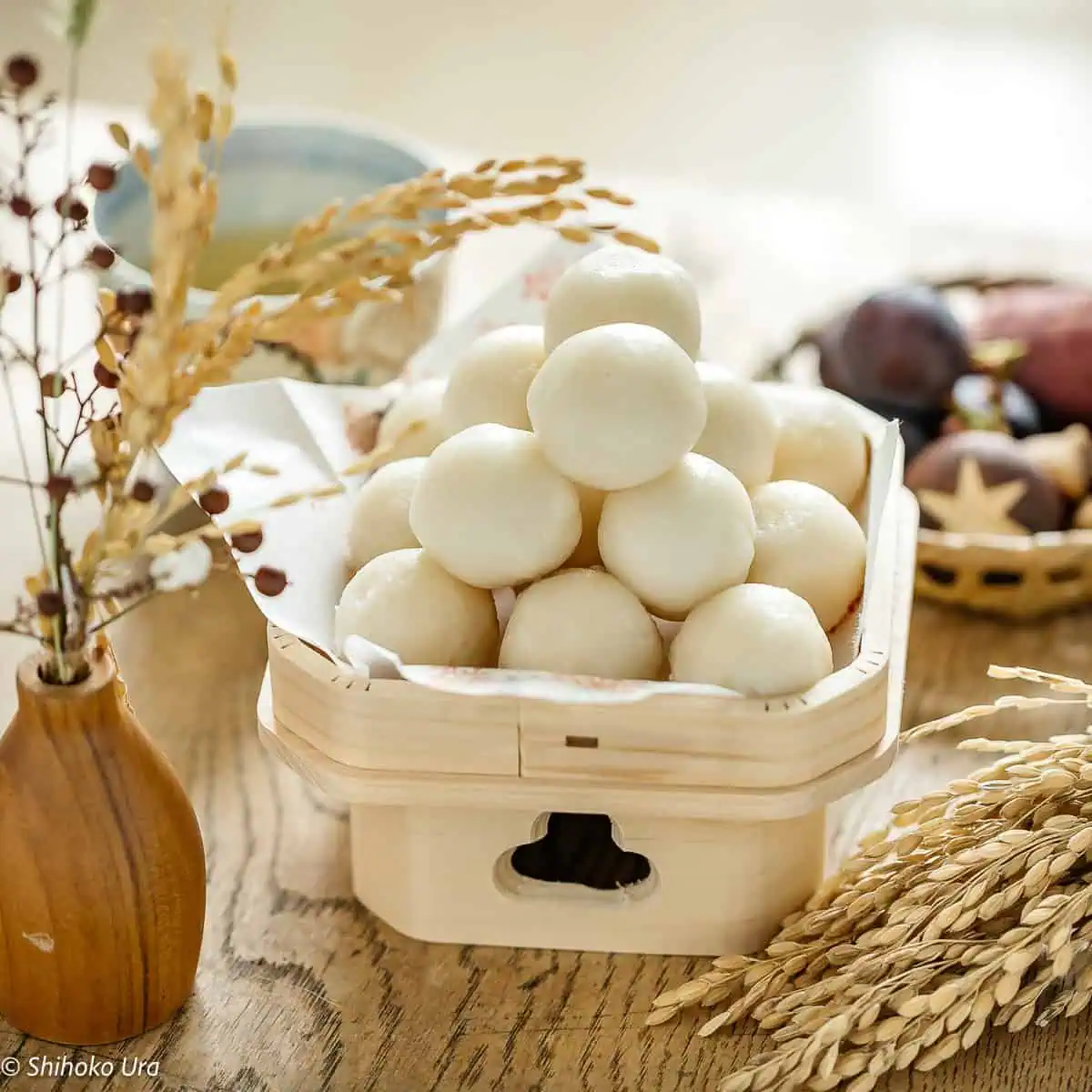 Tsuki dango served on a sanpou (Japanese wooden square stand) with autumn harvests in background